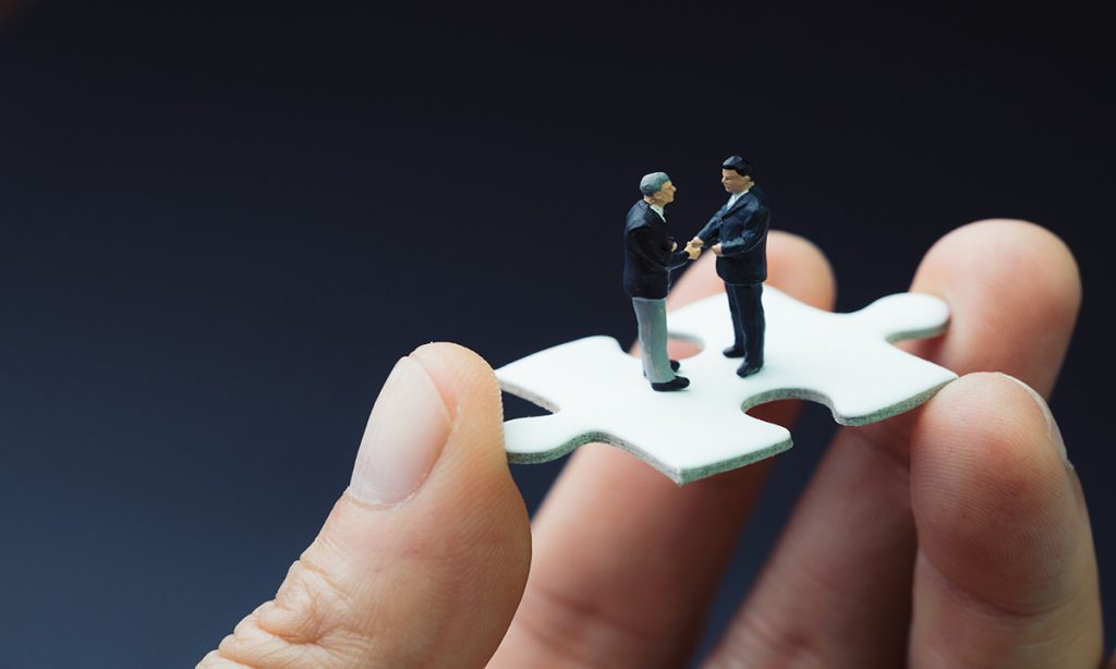 CEOs Beginning Negotiation Standing on Puzzle Piece